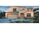 Charming two-story home featuring a desert-landscaped front yard, attached garage, and attractive architectural details at 5236 W Walatowa St, Laveen, AZ 85339
