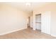 Bright bedroom with light hardwood flooring and access to closet space at 528 N Nevada Way, Gilbert, AZ 85233