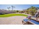 Manicured backyard with artificial turf, stone pavers and lounge chairs at 6202 E Mckellips Rd # 171, Mesa, AZ 85215