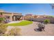 Lush backyard with artificial turf, desert landscaping, and a covered patio area at 6202 E Mckellips Rd # 171, Mesa, AZ 85215
