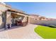Serene backyard with covered patio, artificial grass, desert landscaping and privacy wall at 6202 E Mckellips Rd # 171, Mesa, AZ 85215