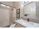 Bathroom vanity features granite countertops and a framed mirror, complemented by a tiled shower with a glass door at 6202 E Mckellips Rd # 171, Mesa, AZ 85215