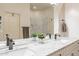Bathroom featuring double sinks with granite countertops, a large mirror, and a walk-in shower at 6202 E Mckellips Rd # 171, Mesa, AZ 85215