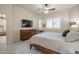 Bedroom with a wood bed frame, television, ceiling fan, and window with plantation shutters at 6202 E Mckellips Rd # 171, Mesa, AZ 85215