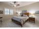 Cozy bedroom with a wood bed frame, neutral bedding, ceiling fan, and window with plantation shutters at 6202 E Mckellips Rd # 171, Mesa, AZ 85215