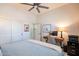 Cozy bedroom featuring a ceiling fan, closet, desk with computer, and an ensuite bathroom at 6202 E Mckellips Rd # 171, Mesa, AZ 85215