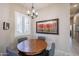 Cozy dining area with wood table, grey chairs, window with shutters and decorative chandelier at 6202 E Mckellips Rd # 171, Mesa, AZ 85215
