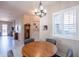 Charming dining area features a wood table, grey chairs, and an elegant chandelier at 6202 E Mckellips Rd # 171, Mesa, AZ 85215