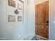 Inviting entryway featuring a wood door, decorative wall art and stylish neutral flooring at 6202 E Mckellips Rd # 171, Mesa, AZ 85215