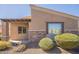 Side of house featuring brick accents, low maintenance gravel landscaping, and covered entry way at 6202 E Mckellips Rd # 171, Mesa, AZ 85215