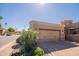 Spacious two-car garage with brick accents, paver driveway, and well manicured shrubbery at 6202 E Mckellips Rd # 171, Mesa, AZ 85215