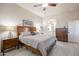 Primary bedroom featuring a wood bed frame, neutral walls, ensuite bathroom, and ample closet space at 6202 E Mckellips Rd # 171, Mesa, AZ 85215