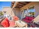 Stylish covered patio with wicker furniture and a view to the house at 6202 E Mckellips Rd # 171, Mesa, AZ 85215
