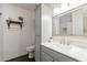 Bright bathroom featuring gray vanity with a sink, and an ornate mirror at 6414 W Monterey Pl, Chandler, AZ 85226