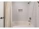 Clean bathroom featuring a shower and bathtub combination with a white tile surround at 6414 W Monterey Pl, Chandler, AZ 85226