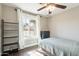 Sun-filled bedroom with a ceiling fan, a large window and stylish wood-look flooring at 6414 W Monterey Pl, Chandler, AZ 85226
