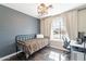 Stylish bedroom featuring gray walls, a large window, and a modern desk space at 6414 W Monterey Pl, Chandler, AZ 85226