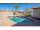 Beautiful backyard pool with stone surround, palm tree and lush green lawn creates a serene outdoor oasis at 6414 W Monterey Pl, Chandler, AZ 85226