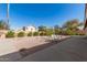Desert landscaped backyard with gravel, trees, bushes, and a swing set at 6456 E Orion St, Mesa, AZ 85215