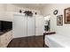 Bedroom featuring wood floors, closet and open door to a full bookshelf at 6456 E Orion St, Mesa, AZ 85215