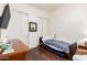 This bedroom features wood floors, white walls and trim, and a hospital bed at 6456 E Orion St, Mesa, AZ 85215
