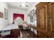 This sunny bedroom features a wood floor, desk, and storage cabinet at 6456 E Orion St, Mesa, AZ 85215