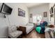 Bright bedroom with natural light, wood floors, an accent chair, and wall-mounted TV at 6456 E Orion St, Mesa, AZ 85215