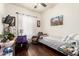 Bedroom featuring wood floors, seating, and a window at 6456 E Orion St, Mesa, AZ 85215