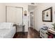 Bedroom featuring wood floors and open door to the ensuite bathroom at 6456 E Orion St, Mesa, AZ 85215