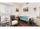 Cozy bedroom featuring hardwood floors, natural light and comfortable seating at 6456 E Orion St, Mesa, AZ 85215