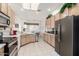 Well-equipped kitchen with stainless steel appliances, granite counters, and ample cabinet space at 6456 E Orion St, Mesa, AZ 85215