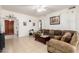 Inviting living room features tile flooring, a ceiling fan, and a large sectional sofa at 6456 E Orion St, Mesa, AZ 85215