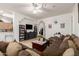 Spacious living room featuring tile floors, an entertainment center, and a large sectional sofa at 6456 E Orion St, Mesa, AZ 85215