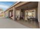 Covered patio featuring tiled flooring, ceiling fan, dining set, and comfortable seating area for relaxing at 6456 E Orion St, Mesa, AZ 85215