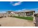 Gravel backyard with a small patch of grass. Covered patio and block wall provide privacy at 6513 W Latona Rd, Laveen, AZ 85339
