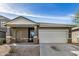 Charming single-story home featuring a two-car garage and covered front porch at 6513 W Latona Rd, Laveen, AZ 85339