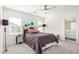 Bright main bedroom with a comfortable queen-size bed and ensuite bathroom access at 6513 W Latona Rd, Laveen, AZ 85339