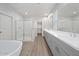 Primary bathroom with dual vanity sinks, a soaking tub, and a glass enclosed shower at 680 W Laredo St, Chandler, AZ 85225