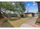 The backyard features a large tree, green grass, and brick walkways at 7226 E Virginia Ave, Scottsdale, AZ 85257