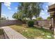 The backyard features a large tree, green grass, and brick walkways at 7226 E Virginia Ave, Scottsdale, AZ 85257