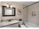 This bathroom has a tub, granite countertops, turtle painting, and a tiled shower at 7226 E Virginia Ave, Scottsdale, AZ 85257