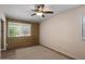 Comfortable bedroom with a large window, ceiling fan, and a brick accent wall at 7226 E Virginia Ave, Scottsdale, AZ 85257