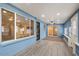 This bonus room features bright blue walls, wood floors, a ceiling fan, and an abundance of light at 7226 E Virginia Ave, Scottsdale, AZ 85257