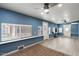 This bonus room features bright blue walls, wood floors, a ceiling fan, and an abundance of light at 7226 E Virginia Ave, Scottsdale, AZ 85257