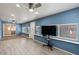 This bonus room features bright blue walls, wood floors, a ceiling fan, and an abundance of light at 7226 E Virginia Ave, Scottsdale, AZ 85257