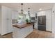 Modern kitchen features white cabinetry, granite countertops, stainless steel appliances, and an island at 7226 E Virginia Ave, Scottsdale, AZ 85257