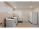 This laundry room features tile floors, a washer, a dryer, and a refrigerator at 7226 E Virginia Ave, Scottsdale, AZ 85257