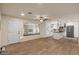 Open-concept living area with an adjacent kitchen featuring white cabinets and stainless steel appliances at 7226 E Virginia Ave, Scottsdale, AZ 85257