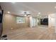 Open living room with brick accent wall, ceiling fan, and wood-look floors at 7226 E Virginia Ave, Scottsdale, AZ 85257