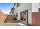 Exterior backyard with gravel and partial concrete, sliding glass door and brick fence at 7446 S 75Th Dr, Laveen, AZ 85339